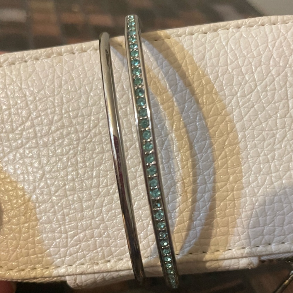 Set of silver bangles.  One solid, second with turquoise. Oval shaped.